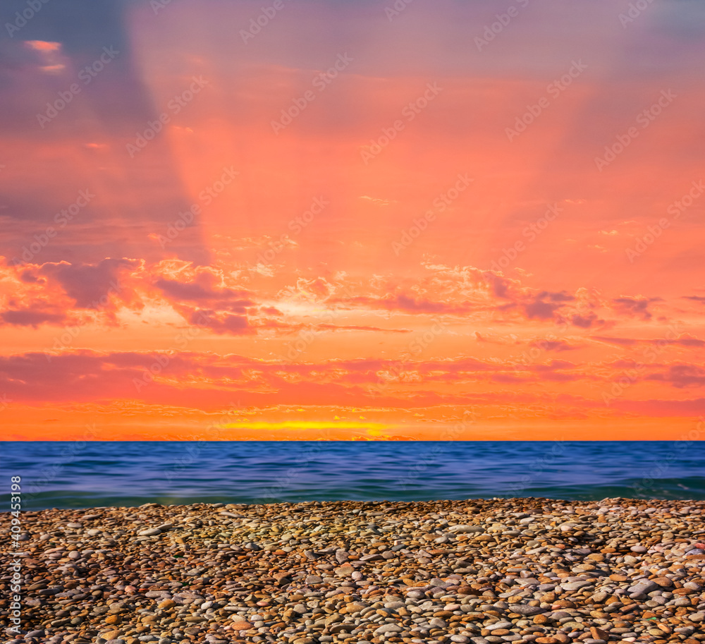 Obraz premium stony sea coast at the dramatic red sunset, natural marine background
