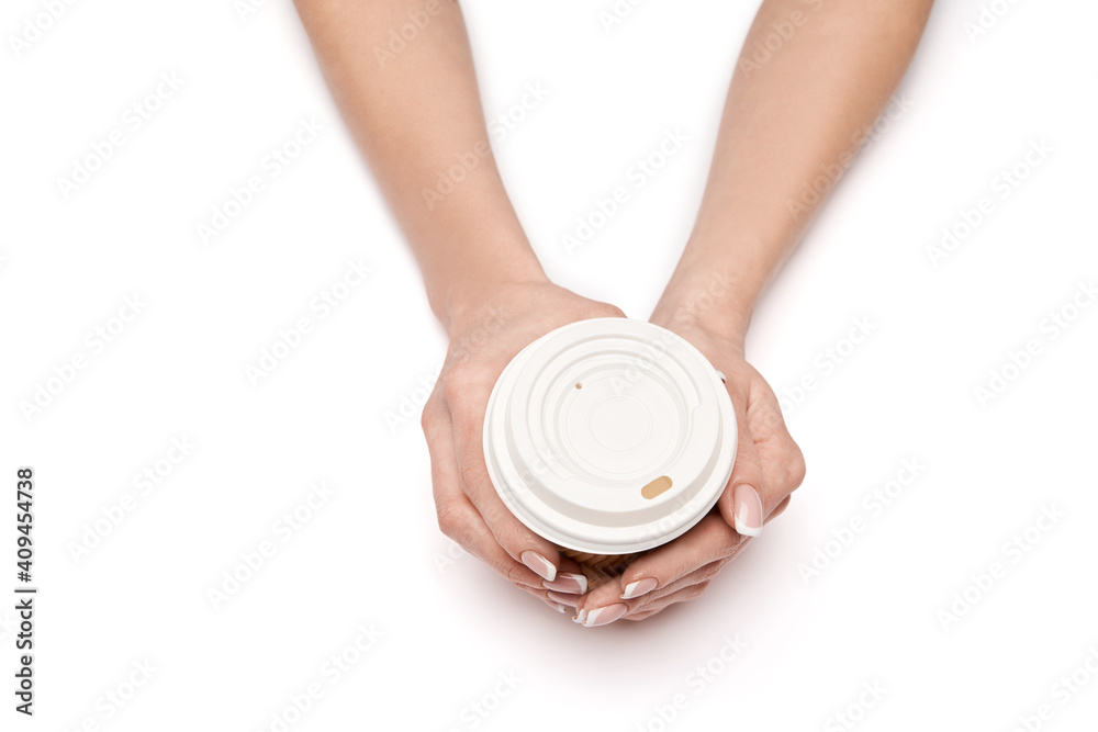 Female hand with paper cup of coffee isolated on white with clipping path Female hand with paper cup of coffee isolated on white with clipping path