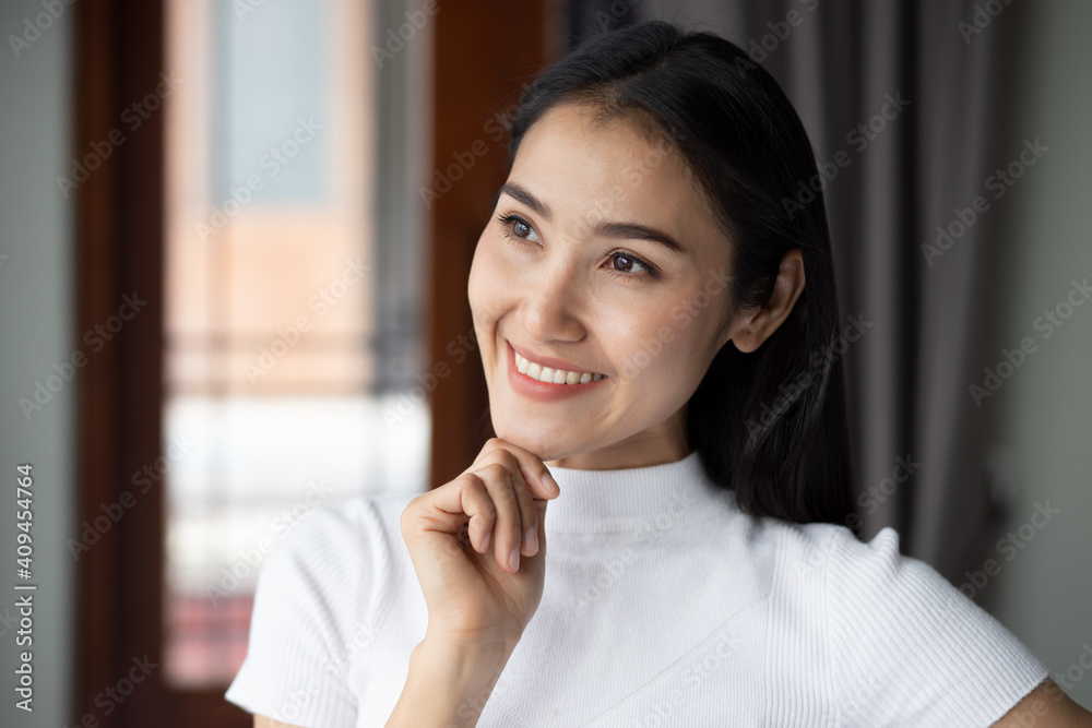 Happy asian woman thinking and planning, portrait of white woman looking up, thinking, finding good idea or decisive plan; adult east asian Chinese woman model