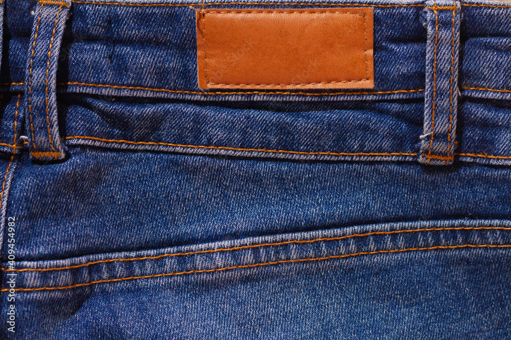 Blue jeans with a blank label and brown stitching. Jeans pocket. Blue jeans with a blank label and brown stitching. Jeans pocket.