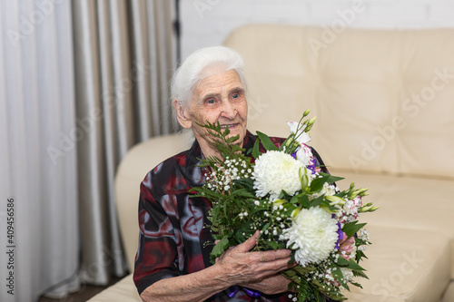 An elderly woman accept congratulations on her 94th birthday