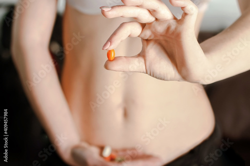 Woman holding a medical tablet in front of her stomach