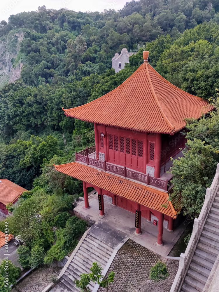 Asian style ancient pagoda building on a hillside among the trees Asian style ancient pagoda building on a hillside among the trees
