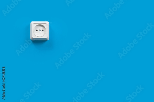 white electrical outlet on a blue wall, background