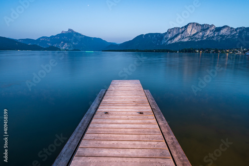 Wooden jetty at lake Mondsee near Salzburg during blue hour