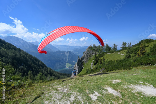 A paraglider ist taking off near the mountain Jenner at the lake Koenigssee
