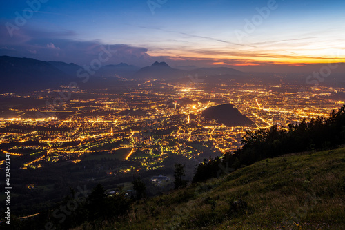 View on lit Salzburg from mountain Gaisberg after sunset