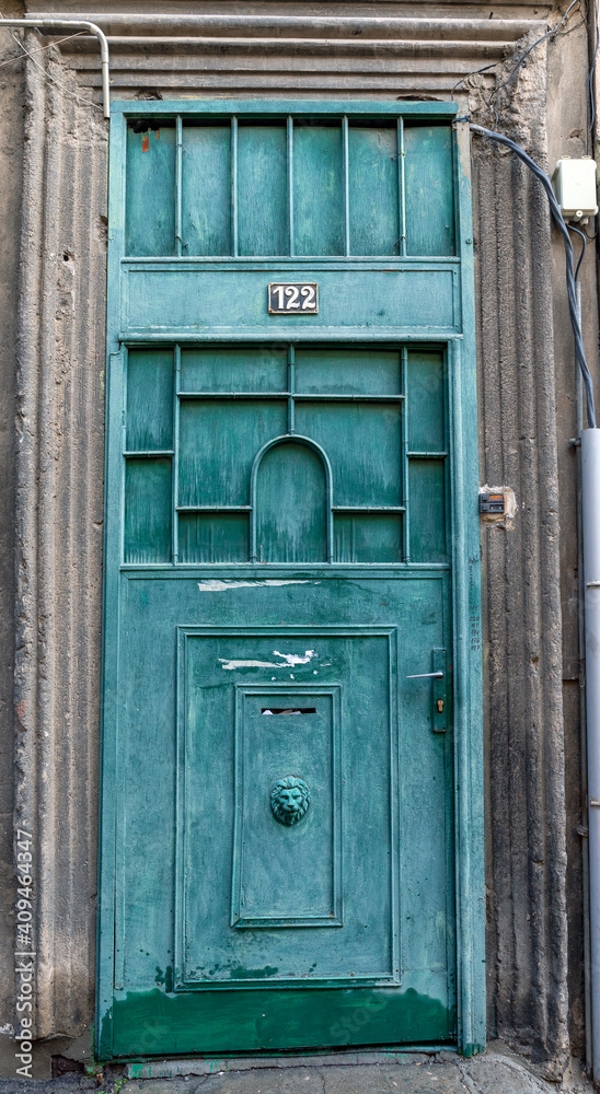 An old green rusty metal door An old green rusty metal door