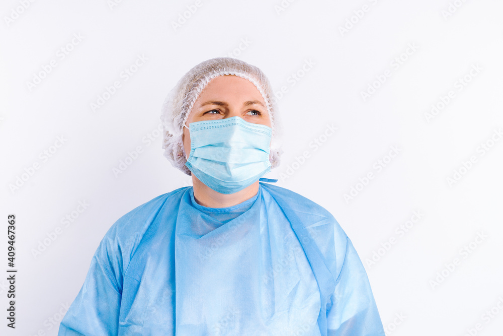 Portrait of a senior female doctor in protective medical equipment against a white background with side blank space. Portrait of a senior female doctor in protective medical equipment against a white background with side blank space.