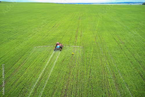 Seasonal agricultural work. Treatment of the field with pesticides using special equipment. Shooting from a drone. Copy space.