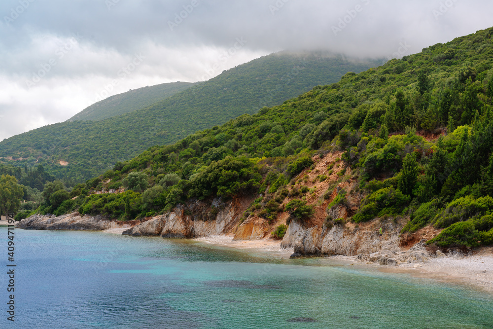 Stunning sea view of beautiful Beach and Lagoon with Blue Water. Mountains with clouds in the sky.