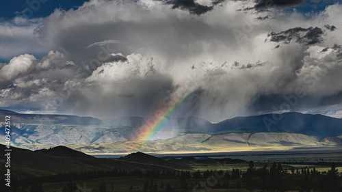 clouds and rainbow over the mountains