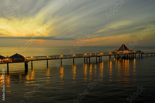 sunset at a pier on the beach