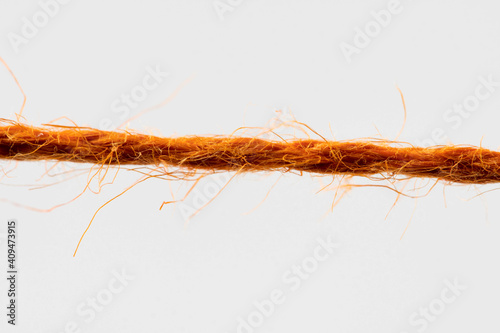 red fibrous rope against white background