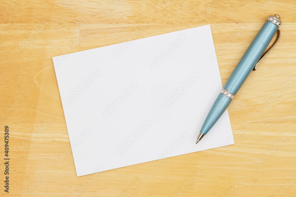Blank note with a pen on a desk Blank note with a pen on a desk