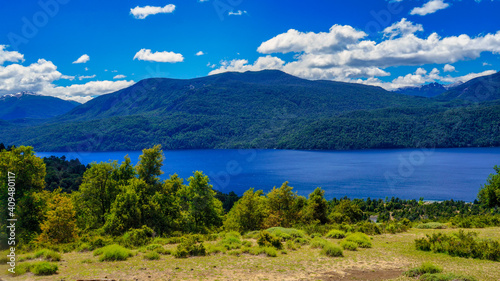 Landscape of lake Lacar, San martin de los Andes, Neuquen, Argentina. Taken on a warm summer afternoon under a ble sky with a few white clouds 