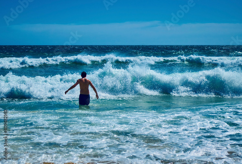 A man in the waves on the beach in South Africa - Western Cape