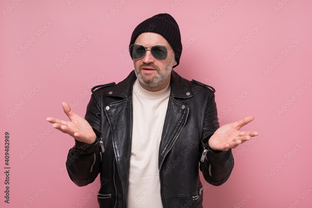 Dissatisfied and displeased man with beard gesturing actively, frowning face while arguing with his friend. Studio shot Dissatisfied and displeased man with beard gesturing actively, frowning face while arguing with his friend. Studio shot