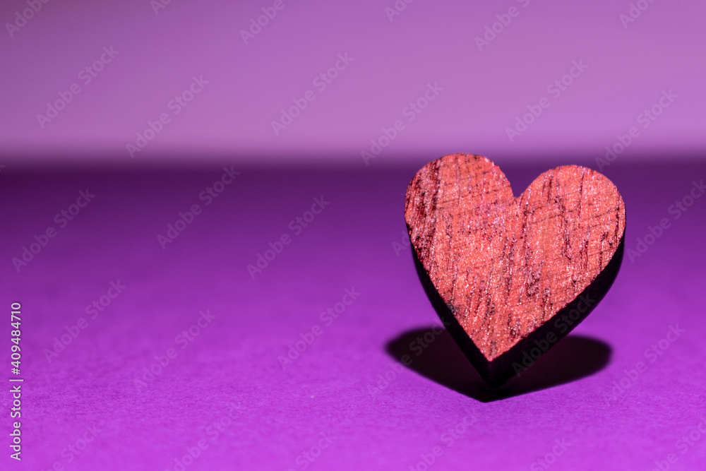 purple background with isolated heart in focus and with its shadow purple background with isolated heart in focus and with its shadow
