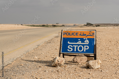 Police stop sign in desert road photo