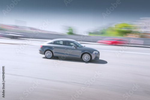 Touring car sweeping at speed in the city. Transportation concept. © dhvstockphoto