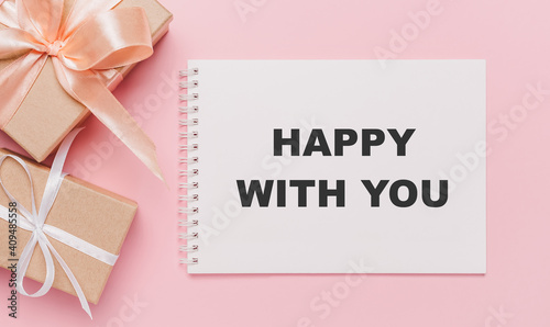 Gifts with note letter on isolated pink background, love and valentine concept with text happy with you