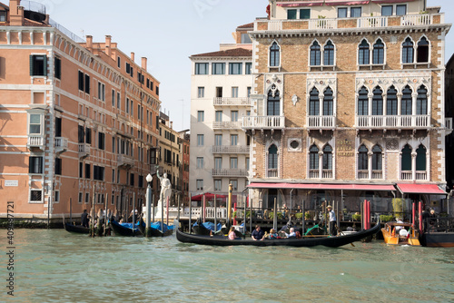The gondolier floats on a gondola with tourists