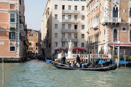 The gondolier floats on a gondola with tourists