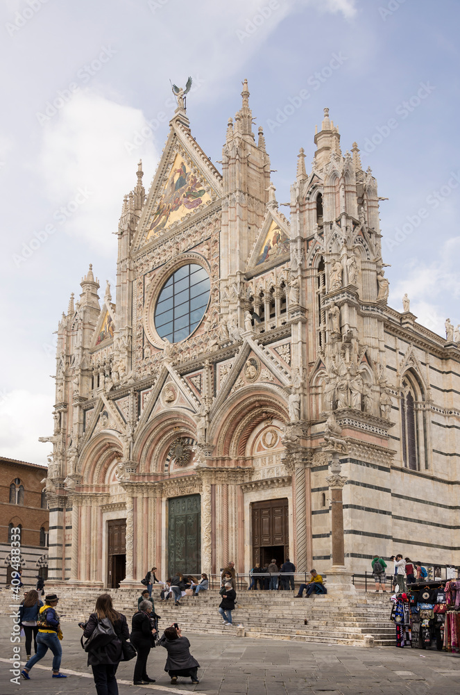 Tourists visiting Siena Cathedral, dedicated to the Assumption of the Blessed Virgin Mary
