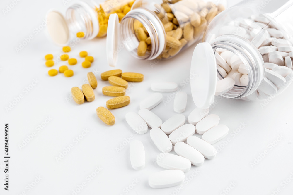 Orange pills, white capsules open transparent bottles with white background. Nutritional supplements, vitamins. Omega 3, multivitamins, Calcium, antibiotics. Medication, pills. Health. Immunity Orange pills, white capsules open transparent bottles with white background. Nutritional supplements, vitamins. Omega 3, multivitamins, Calcium, antibiotics. Medication, pills. Health. Immunity