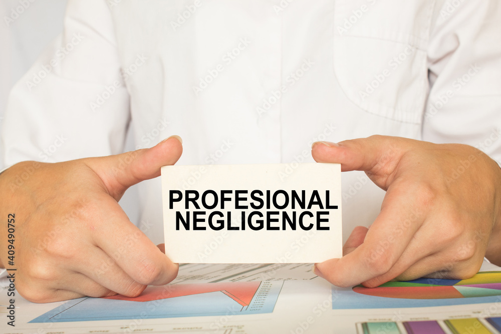 a man in the office holds a card with text PROFESSIONAL NEGLIGENCE . business concept a man in the office holds a card with text PROFESSIONAL NEGLIGENCE . business concept