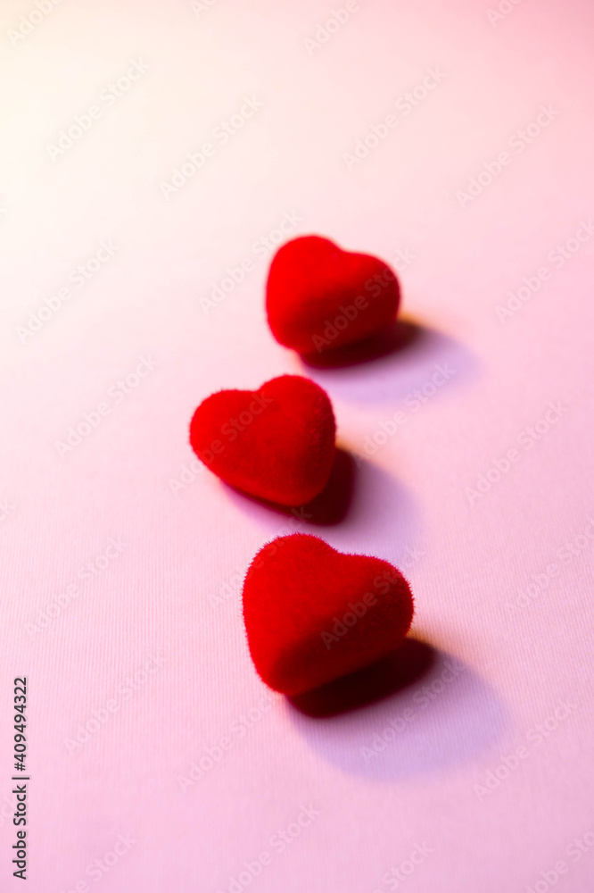 Obraz premium Valentine's Day. A red heart lies on a pink surface. Heart on a pink background. Love. 