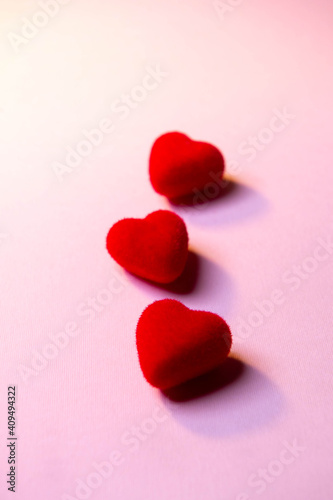 Valentine's Day. A red heart lies on a pink surface. Heart on a pink background. Love. 
