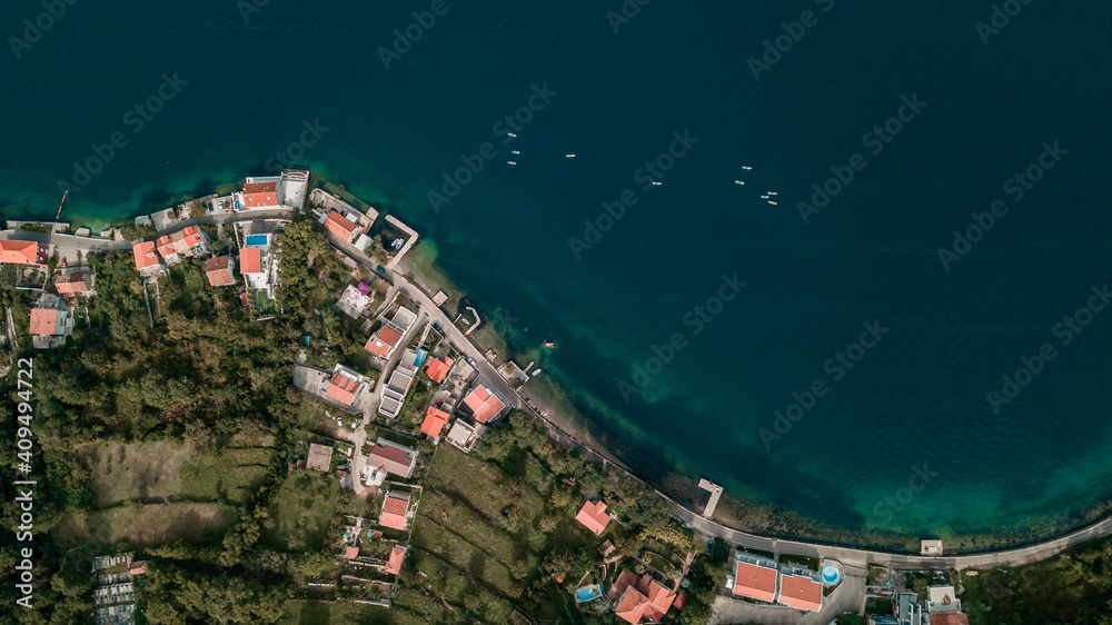 Aerial view of group of people with SUP Stand up paddle boards in blue water of  Kotor bay (Boka Kotorska), Montenegro, Europe
