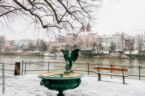 Basel, Basiliskbrunnen, Basilisk, Brunnen, Rhein, Rheinufer, Kleinbasel, Altstadt, Stadt, Winter, Schnee, Schneedecke, Basel-Stadt, Grossbasel, Münster, Schweiz photo