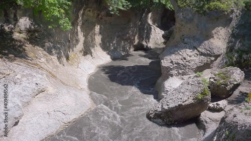 Khadzhokh gorge. View of the end of the Belaya river gorge. in the middle of the river there is a high rock of limestone rock - Aminovskaya platform. Kamennomostsky. Beautiful movement of the river photo