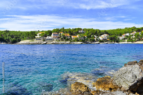 Beautiful Adriatic sea in Croatia in summer. Blue lagoon, houses in green pines, rocky coast. Mudri Dolac, Basina bay