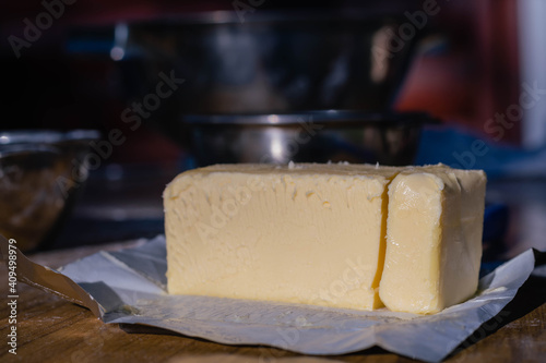 close-up of rectangular dairy butter bread for gastronomy and food preparation on glass with knife with sunlight
