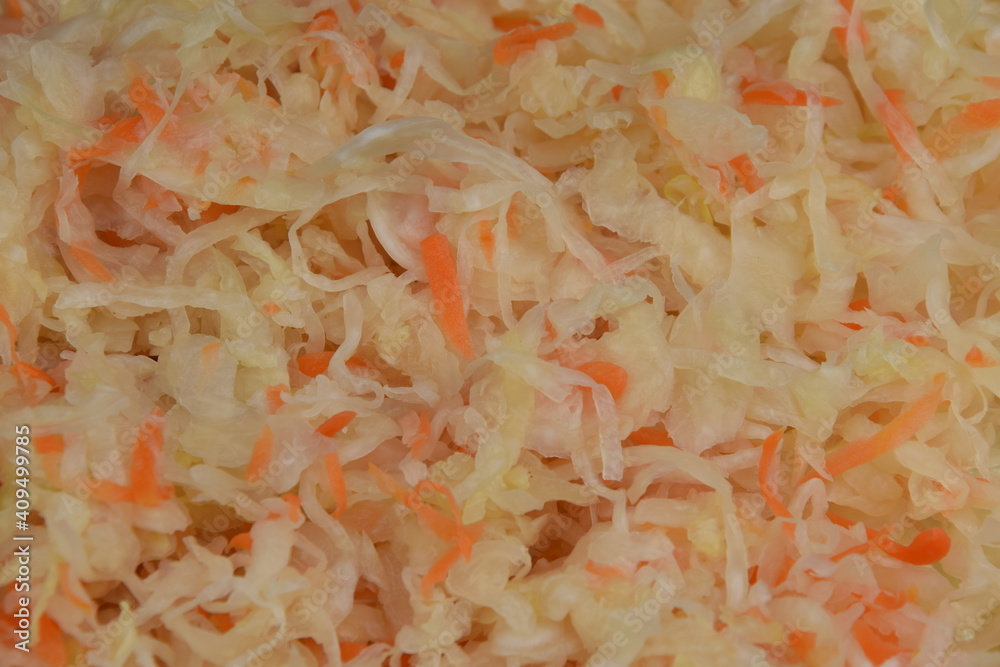 Sauerkraut with carrot - closeup of sour cabbage source of vitamins and probiotics Sauerkraut with carrot - closeup of sour cabbage source of vitamins and probiotics