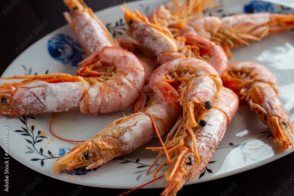 Fresh and delicious seafood, cooked shrimps. Whole cooked tiger prawn on dish.Selective focus. Fresh and delicious seafood, cooked shrimps. Whole cooked tiger prawn on dish.Selective focus.