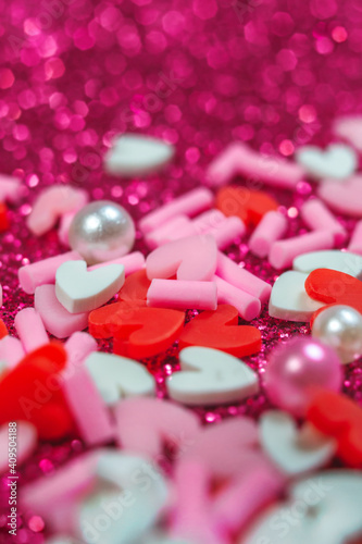Heart candy confetti, pearl on purple sparkle background. 14 february, valentines day macro concept. Blurred bokeh banner template with copy space. Holiday love card. Selective focus