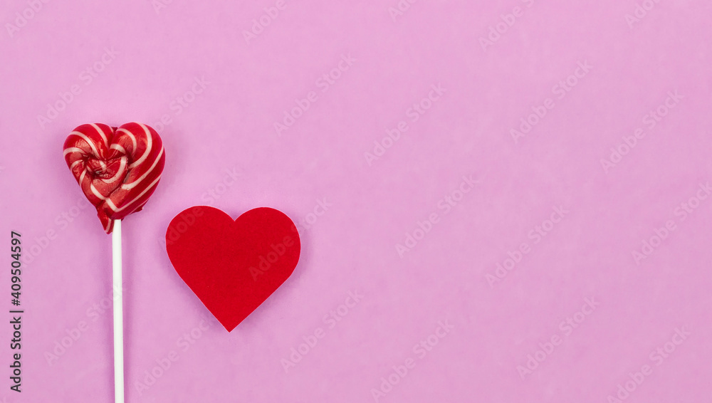 Pink Valentine's day heart shape lollipop candy on empty pastel pink paper background. Love Concept. top view. Minimalism colorful hipster style.