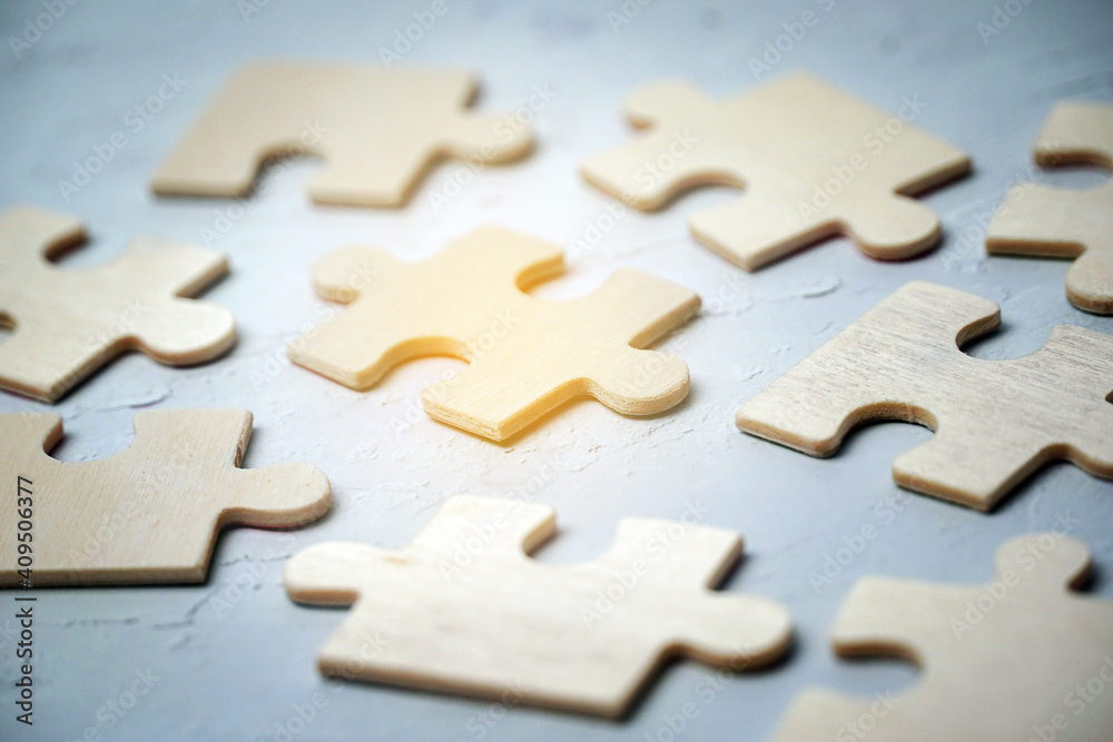 Close up piece of white jigsaw puzzle , concept of business challenge completion with teamwork Close up piece of white jigsaw puzzle , concept of business challenge completion with teamwork