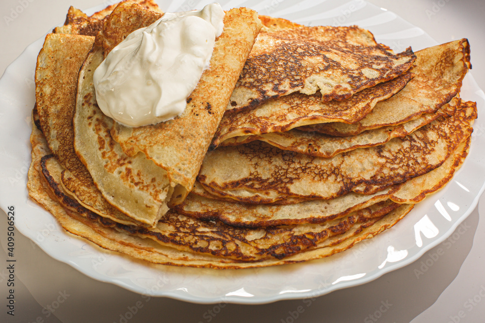  Photo Delicious thin Pancakes With Sour Cream. Traditional Russian Dish. Restaurant Serving.