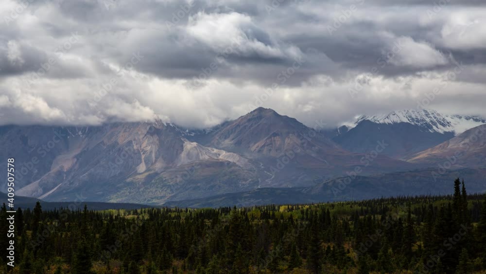 Canadian Rocky Mountain Landscape during a cloudy and sunny day in Fall Season. View from Alaska Highway in Yukon, Canada. Time Lapse Canadian Rocky Mountain Landscape during a cloudy and sunny day in Fall Season. View from Alaska Highway in Yukon, Canada. Time Lapse