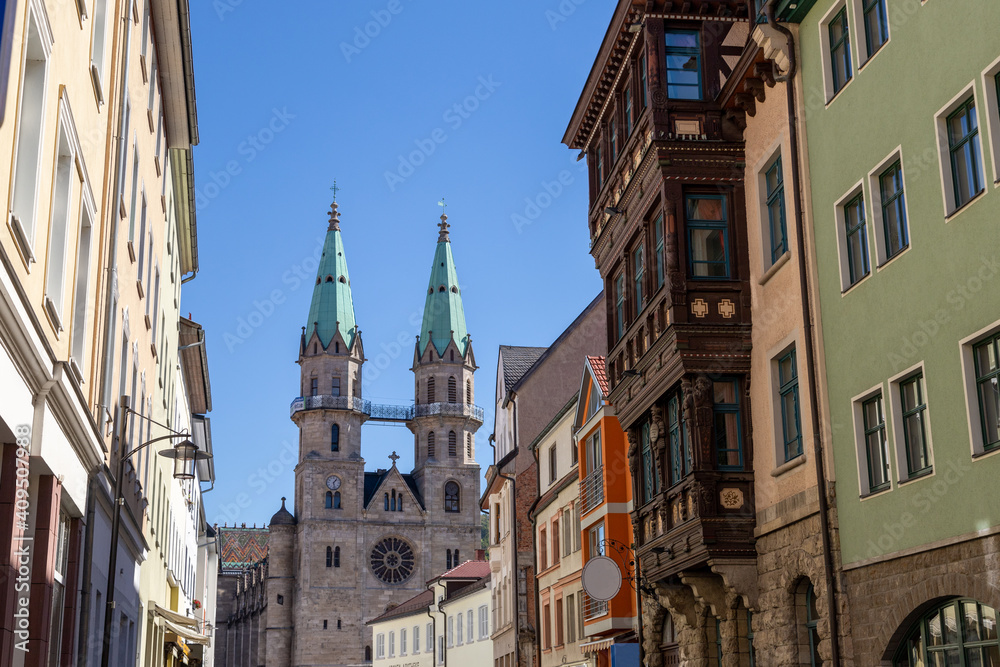 Street with house facades and view to the town church in Meiningen
