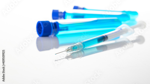 Medical needles. Medical syringe with needle for protection flu virus and coronavirus. Covid vaccine on white. Nurse or doctor. Liquid drug or narcotic.