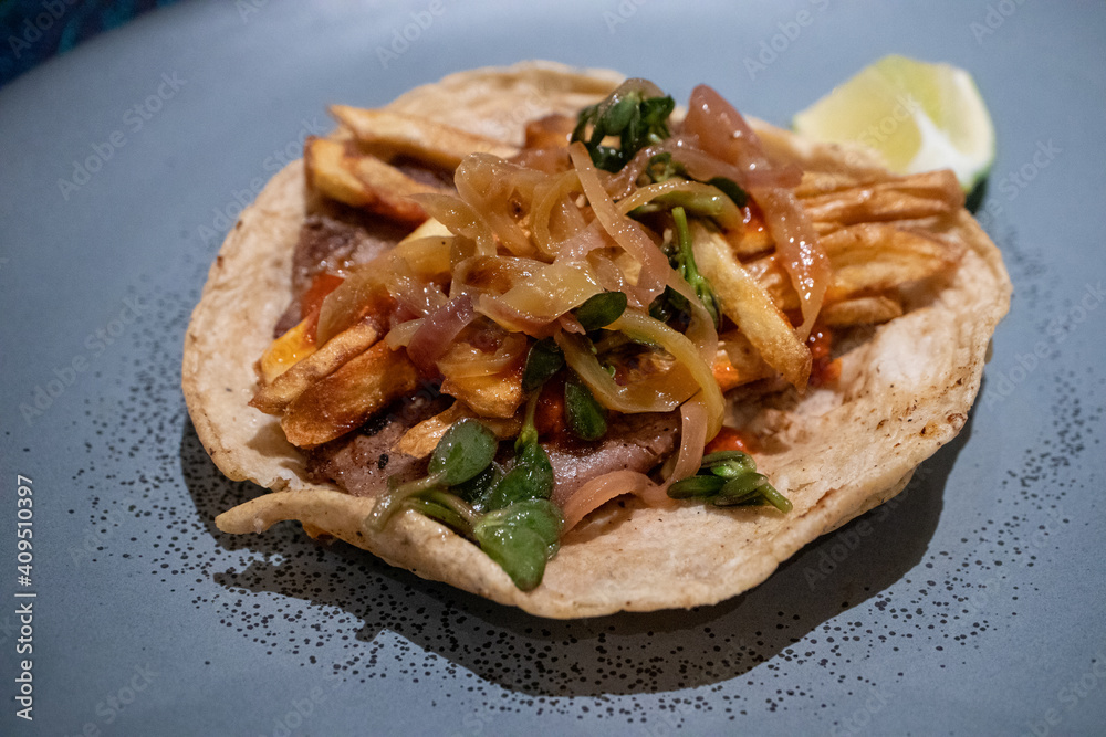 Taco Gaonera - a delicious taco made with grilled beef (Bistec) and topped with French fries.