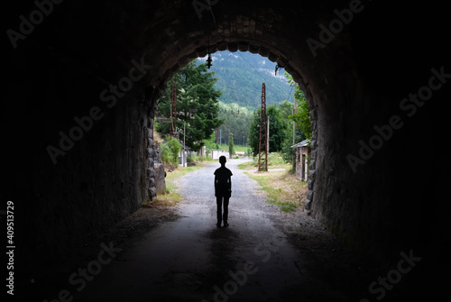 Silhouette of a person in a tunnel