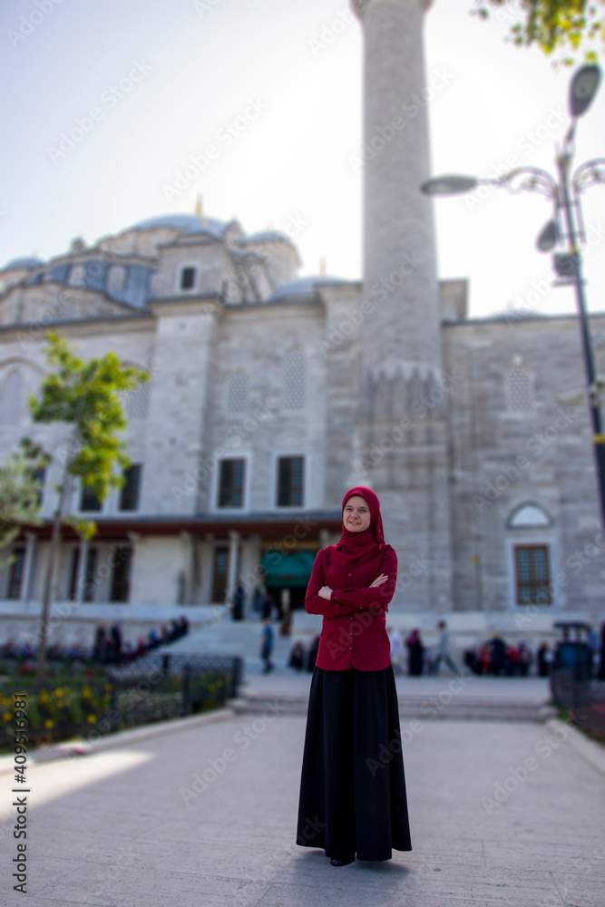 Tourist girl posing in front of Fatih mosque in Istanbul